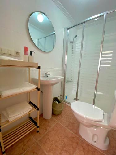 a bathroom with a toilet and a sink and a shower at Corazón de Santa Pola in Santa Pola