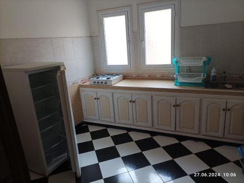 une cuisine avec un comptoir et deux fenêtres et une cuisinière dans l'établissement Wohnung Drehte Etage 3 Schlafzimmer, à Segangane