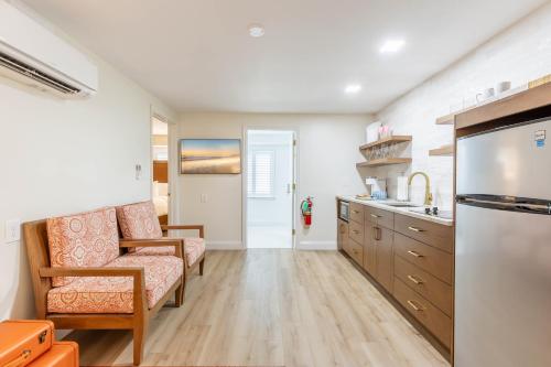 a kitchen with a couch and a chair at The Beach Club on Madison Avenue in Cape May