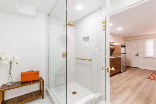 a shower in a bathroom with a glass door at The Beach Club on Madison Avenue in Cape May