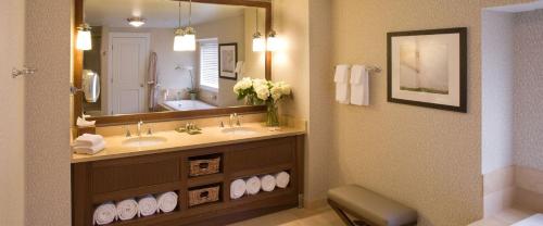 a bathroom with two sinks and a large mirror at Inn By the Sea in Cape Elizabeth