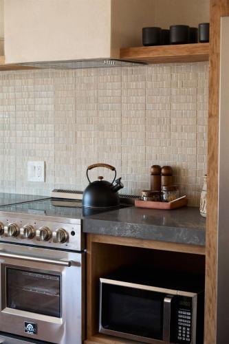 a kitchen with a stove and a tea kettle at Sand Castle in Imperial Beach