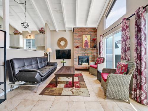 a living room with a couch and chairs and a fireplace at 3607 Seashore Dr B in Newport Beach