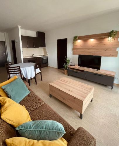 a living room with a couch and a coffee table at Art Hotel Babylon in Sunny Beach