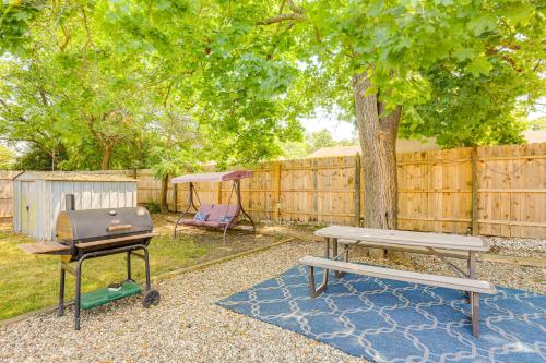 a picnic table and a grill in a backyard at Bayville Getaway with Fire Pit - 2 Mi to Beach! in Bayville