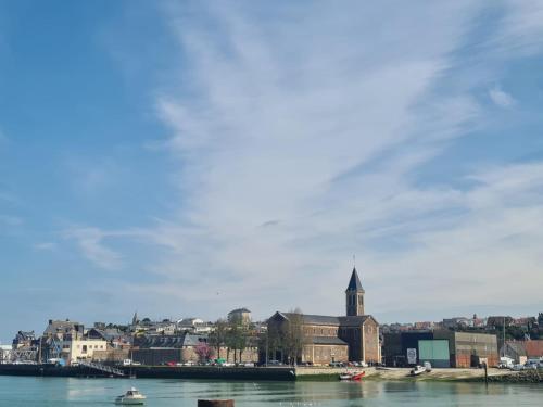 a view of a city from the water with a church at Beau 2 pièces charme et confort in Dieppe