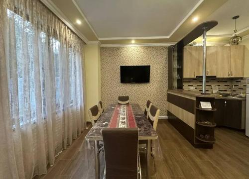 a dining room with a long table and chairs at RiverSide Guest House in Dilijan