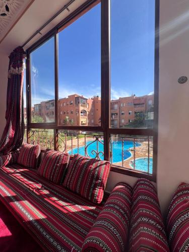 a couch in a room with a large window at Mansoria,mohamedia in Pont Blondin