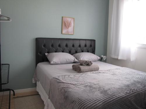 a bedroom with a bed with a teddy bear on it at RCM Vilas - Apartamento n 12 in Joinville