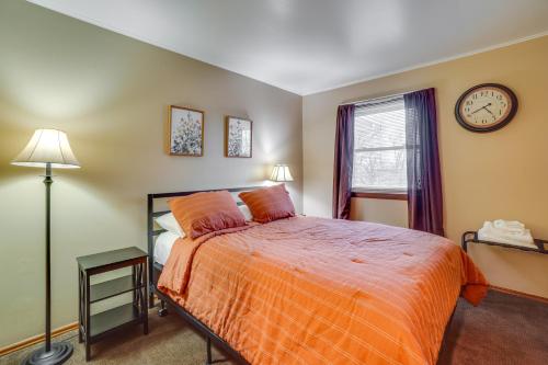 a bedroom with a bed and a clock on the wall at Shell Knob Home with Fire Pit, Near Table Rock Lake! in Shell Knob