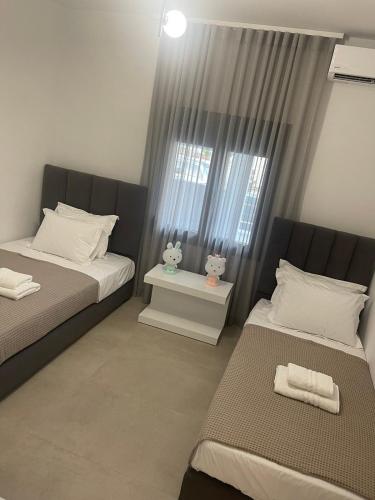 a bedroom with two beds and a window at Sofia's House in Nea Moudania