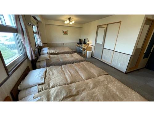 a room with three beds in a room at Fuji Park Hotel - Vacation STAY 23859v in Fuji