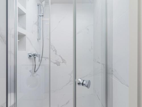 a shower with a glass door in a bathroom at Apartment - Main Square in Kraków