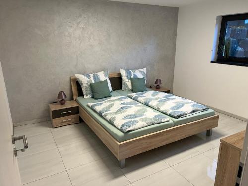 a bedroom with a bed with pillows on it at Moderne Ferienwohnung im Kurort Tengen-Neubau, Erstbezug in Tengen