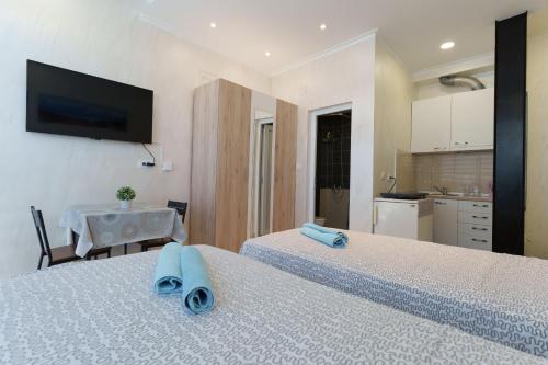 a bedroom with two beds with blue towels on them at Step rooms apt spa in Belgrade