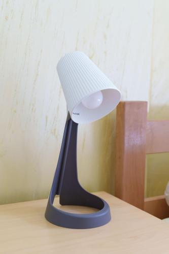 a white lamp sitting on top of a desk at Step rooms apt spa in Belgrade