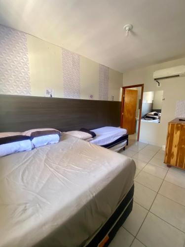 Katil atau katil-katil dalam bilik di Residencial pimenta - aluguel temporada - apto mobiliado