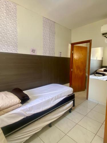 Katil atau katil-katil dalam bilik di Residencial pimenta - aluguel temporada - apto mobiliado