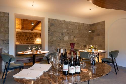 a dining room with wine bottles on a table at Gargiulo Resort in Sant'Agnello