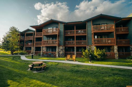 a large apartment building with a picnic table in front of it at Lake Louise Inn in Lake Louise