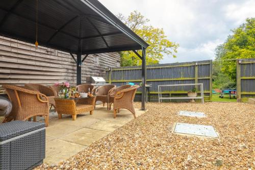 a patio with a table and chairs and an umbrella at The Anchor in Sutton