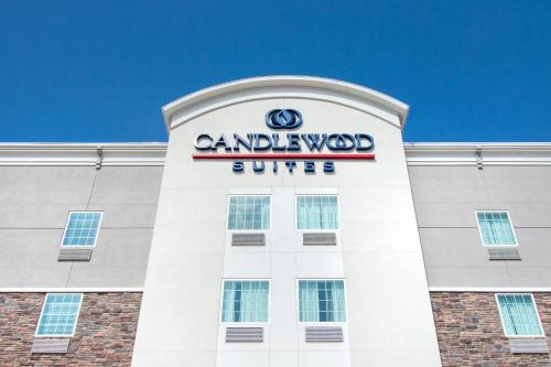 a building with a sign on top of it at Candlewood Suites Waco by IHG in Waco