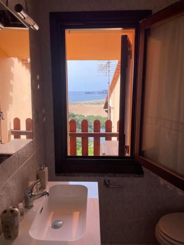 a bathroom with a sink and a view of the ocean at Casa Vacanza Suite Violet in Torre Dei Corsari