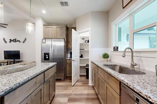 a kitchen with a sink and a refrigerator at Tequila Mockingbird in Canyon Lake