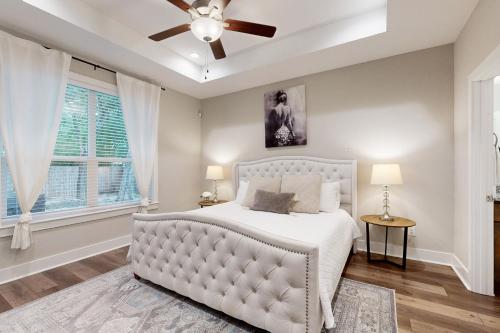 a bedroom with a white bed and a ceiling fan at Tequila Mockingbird in Canyon Lake