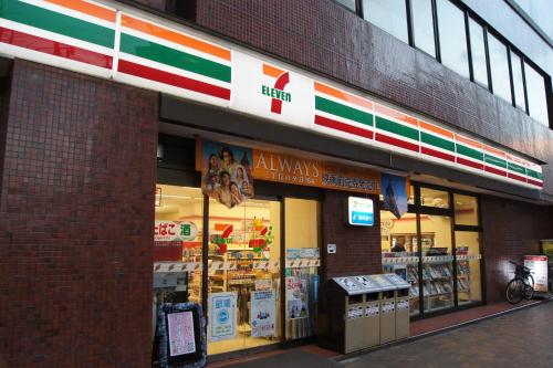 a store front of a brick building with a grocery store at Tabist Hotel Tetora Kitakyushu in Kitakyushu