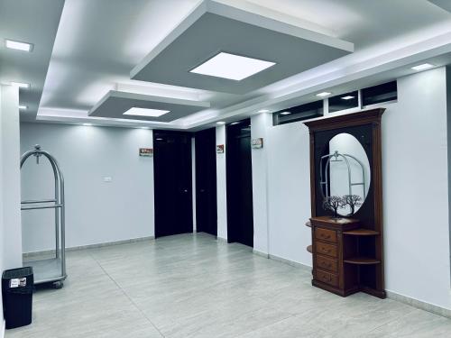 a dressing room with a mirror and a vanity at Hotel Tiwintza Internacional in Quito