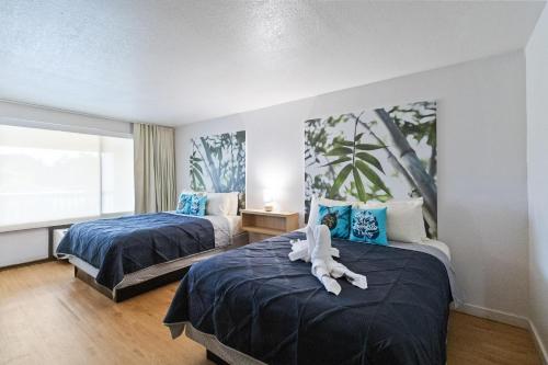 a bedroom with two beds with an animal on them at 11 Condo-Hotel With Double Bed And Community Pool Miles From Disney! in Kissimmee