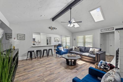 a living room with a couch and a table at The Stylish Villa & Pool in DFW in Bedford