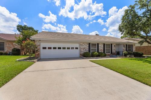 a house with a driveway and a garage at The Stylish Villa & Pool in DFW in Bedford