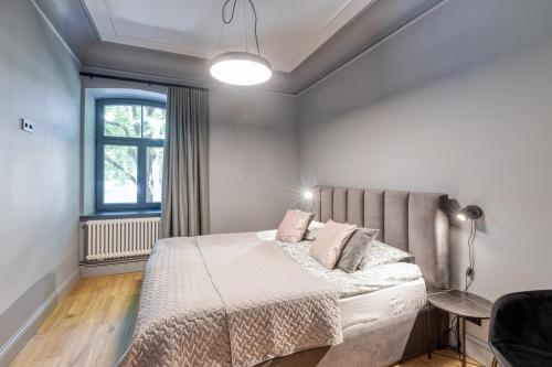 a bedroom with a bed and a window at Apartments Vitenberg in Cēsis