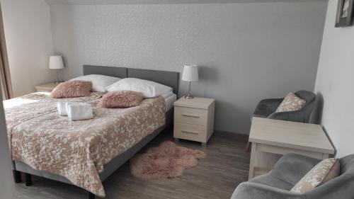 a bedroom with a bed with a desk and a chair at Za Gościńcem in Kazimierz Dolny