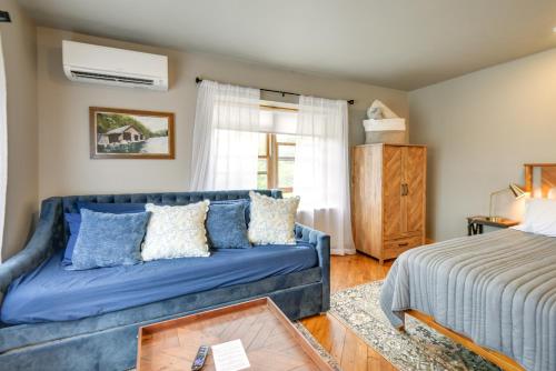 a living room with a blue couch and a bed at Meredith Studio Near Downtown Hike, Swim, Ski! in Meredith