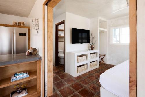 a room with a bed and a tv on a wall at Sand Castle in Imperial Beach