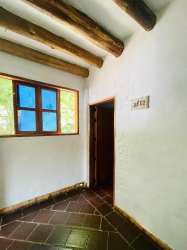 an empty room with a window and a door at Hotel Victoria Barichara in Barichara