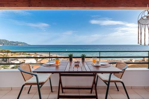 a table on a balcony with a view of the beach at Etherial Stay in Corfu island Home166 in Glyfada