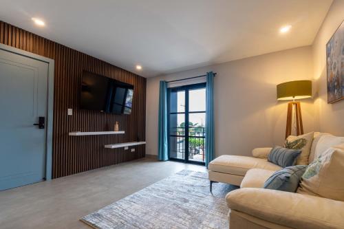 a living room with a couch and a tv at Suites Miramar14 in Ensenada