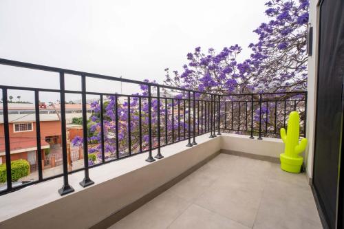 a balcony with a view of purple flowers at Suites Miramar14 in Ensenada
