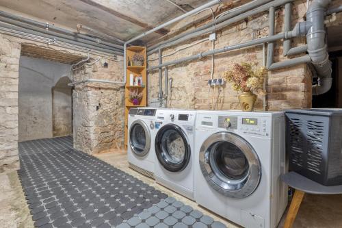 a laundry room with a washer and dryer at Apartments Vitenberg in Cēsis