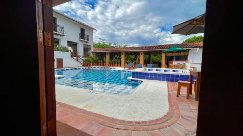 a swimming pool in the middle of a house at Hotel Victoria Barichara in Barichara