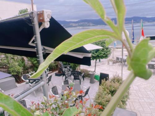 a view of a patio with tables and chairs at HOTEL MAREA in Poio