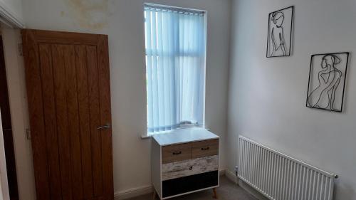 a room with a window and a wooden door at 2 bedroom house perfect for contractors in Birmingham