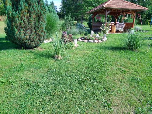 a garden with a gazebo in a yard at Nika in Ogulin