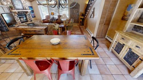 a dining room with a wooden table and chairs at River Ritz - Pet Friendly - WiFi - Near the Ski Area - Fireplace - On the River - Washer - Dryer - in Red River