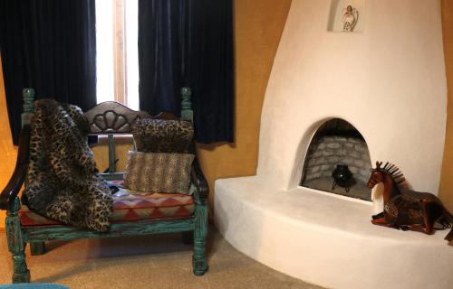 a room with a chair and a horse in a fireplace at River Ritz - Pet Friendly - WiFi - Near the Ski Area - Fireplace - On the River - Washer - Dryer - in Red River