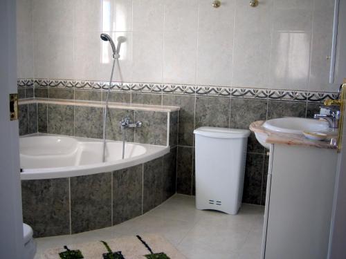 a bathroom with a tub and a sink at Casa Sara - Private Villa with Private Pool in Ciudad Quesada